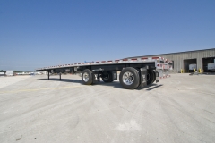 Flatbed trailer outside by commercial building in Minot, ND