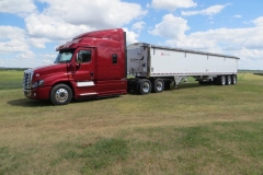 Red semi with white trailer, second view from the front