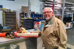 Trailer repair shop interior with staff member