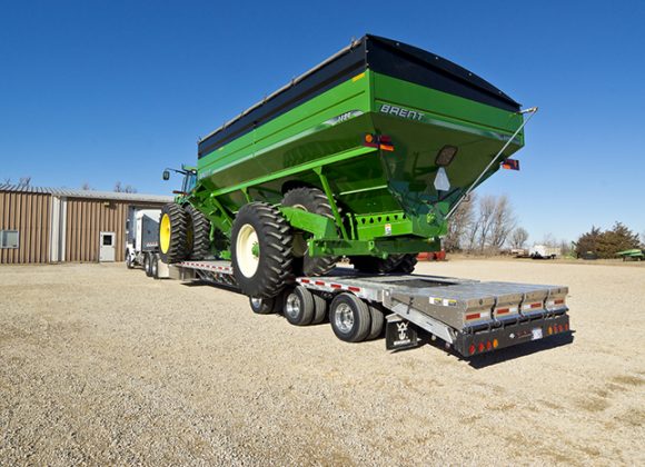 a large green trailer being toed and other Grain Trailer Sales, Hopper Trailers for Sale, and Used Trailers in Dickinson, ND