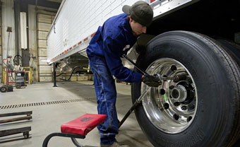 technician changing a tire and providing Trailer Service in Grand Forks, ND