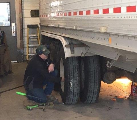 Man Working on Tires of Trailer for Trailer Service in Watford City, Jamestown, Dickinson, Minot, Williston