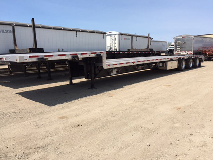 Used trailers with a white trailer on a dirt road in Bismarck, ND